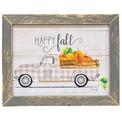 Grey distressed mitered frame around a vintage inspired wooden sign. Sign displays old farm truck with wood rail along the truck bed. Truck is patterned with a plaid pattern and white wall tires. Truck bed full of pumpkins of various sizes. Decorative "Happy Fall" scrolled across the top of the wood sign.