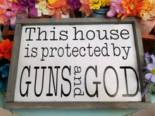 Load image into Gallery viewer, This house is protected by Guns and God, rustic farmhouse decor, wall art, ready to ship
